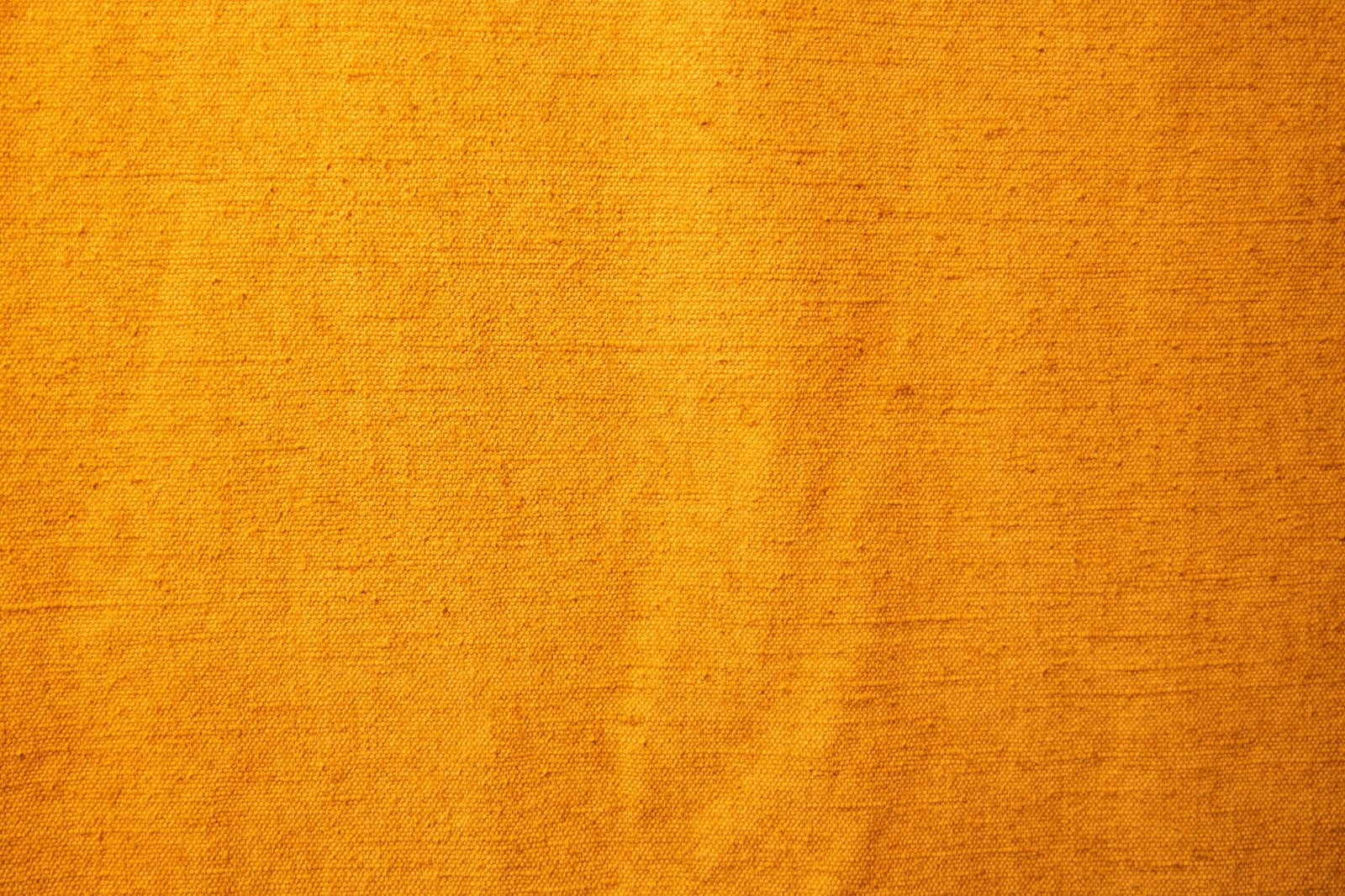 Detailed view of yellow textile fabric showcasing its texture and pattern.
